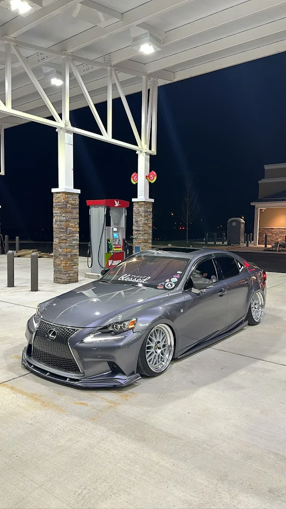 Lowered Lexus IS with a mirror finish photographed at night