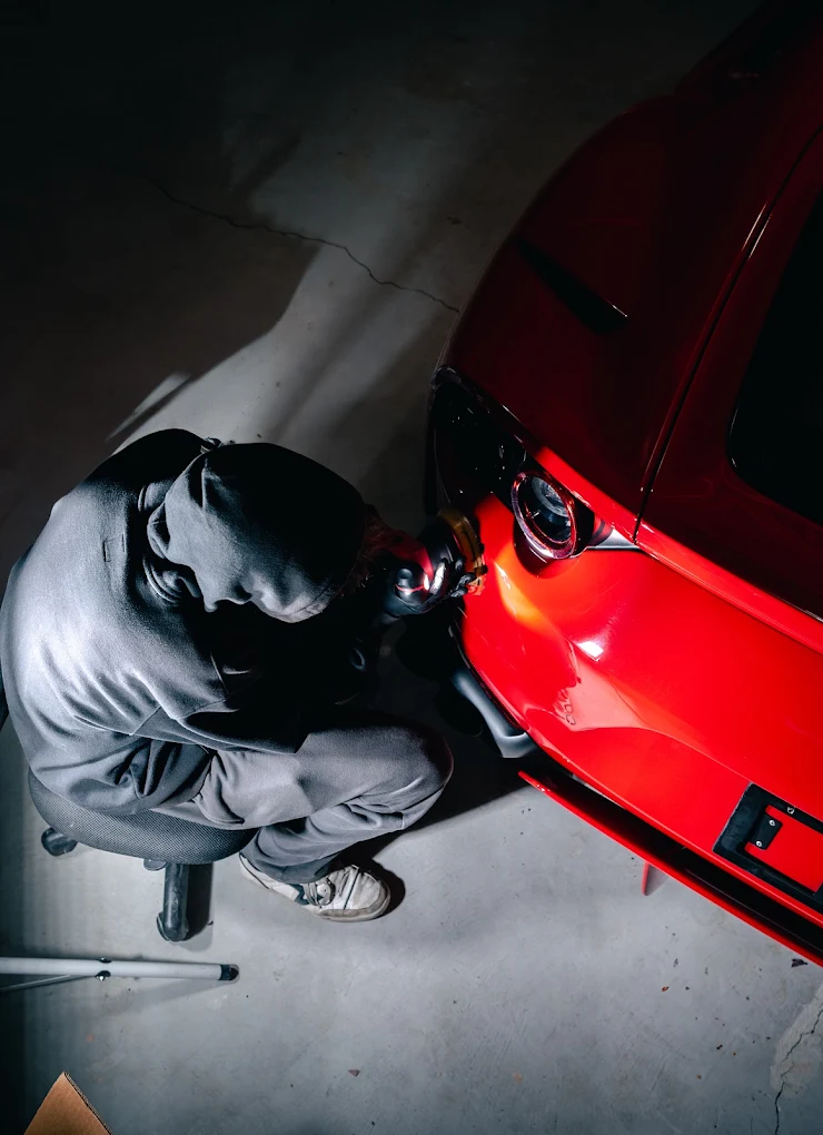 Machine polishing the front end of a red Ferrari 812