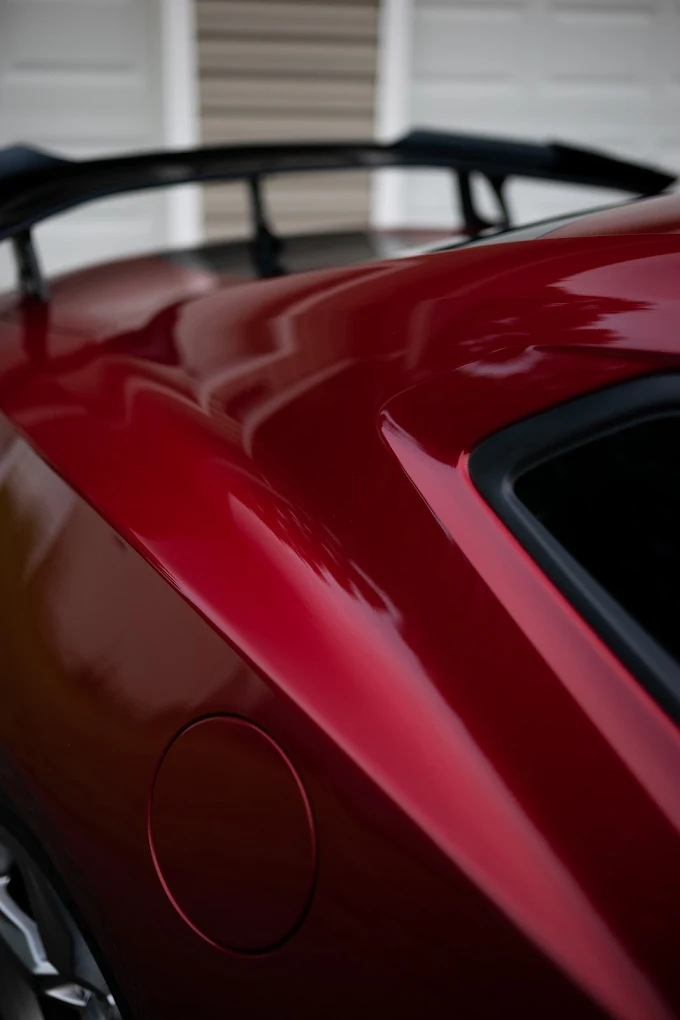 The same red panel with deep wet-look gloss after ceramic coating