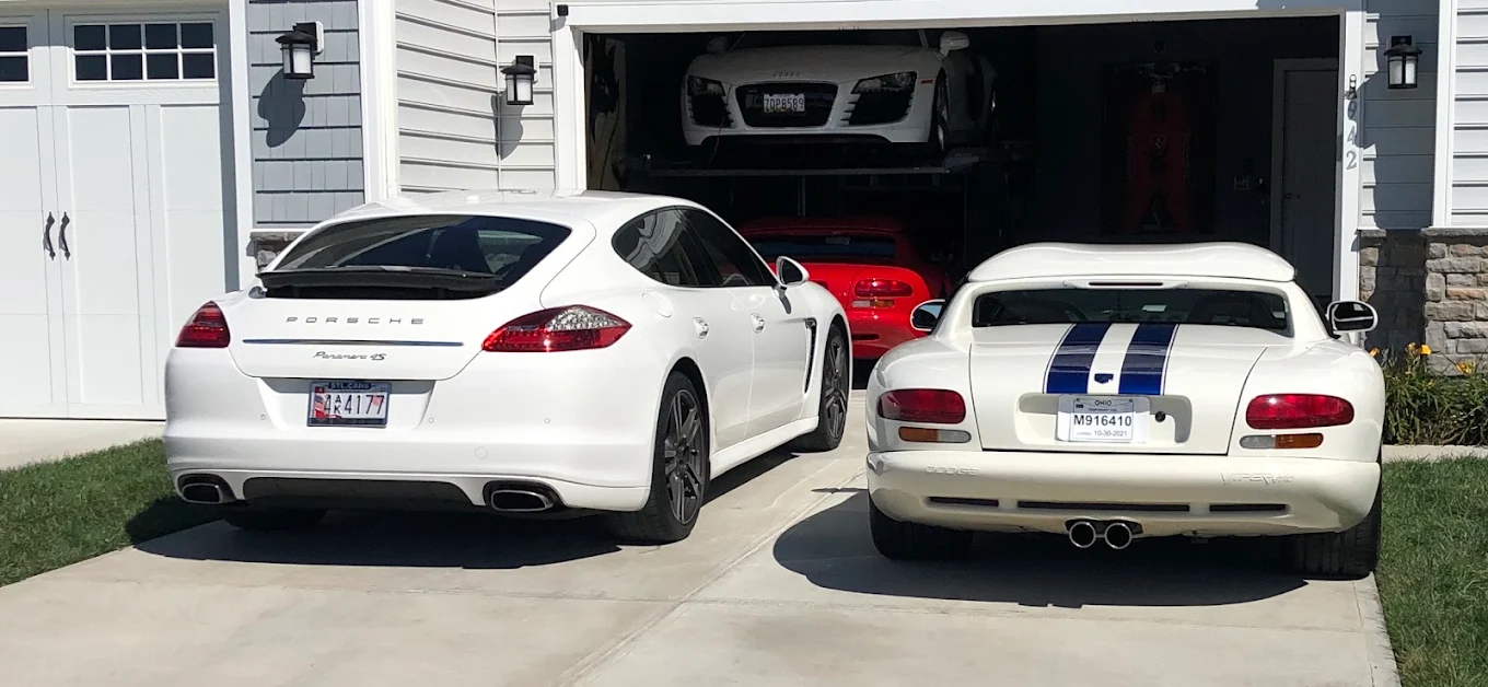 Clean, dimly lit automotive detailing bay with green accent lighting